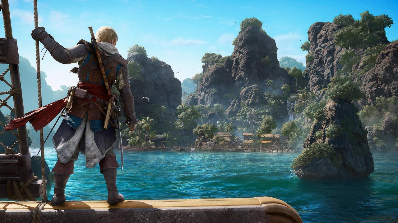 Edward Kenway stands on the Jackdaw looking toward a Caribbean island in Assassin’s Creed Black Flag Resynced.