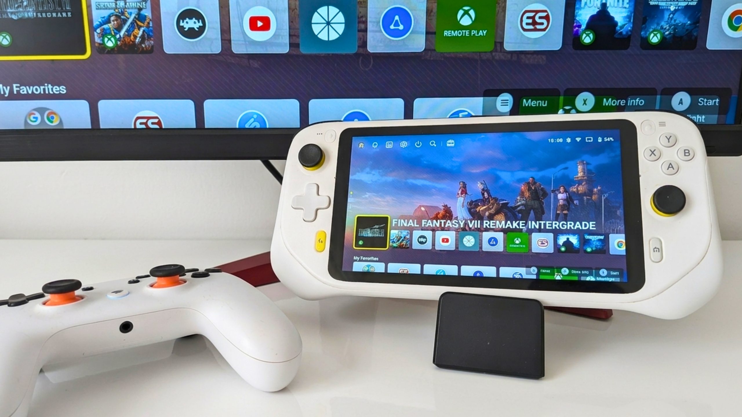 dock 3 White handheld gaming console and controller beside a screen showing Final Fantasy VII Remake Intergrade