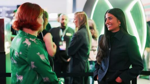 Asha Sharma speaking with a BBC interviewer at the XBOX booth during gamescom 2026