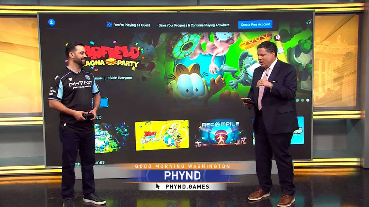 Ney Castro demonstrates PHYND on Good Morning Washington in front of a TV showing Garfield Lasagna Party.