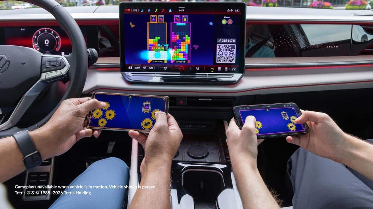 Tetris running through AirConsole on a Volkswagen infotainment display while two smartphones are used as controllers.